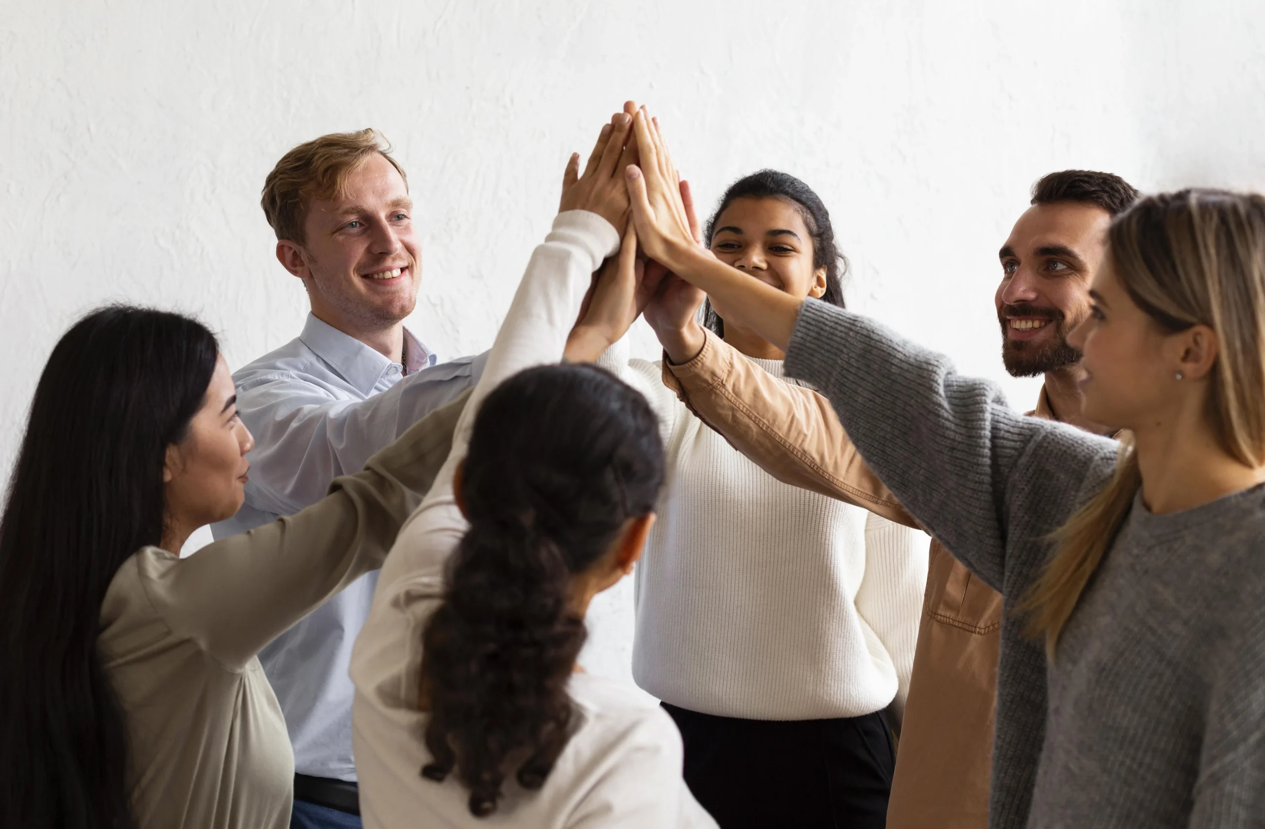 happy-people-high-fiving-each-other-group-therapy-session